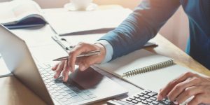 businessman working in office with using calculator and laptop. concept finance and accounting